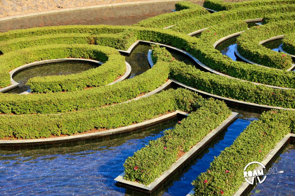 A flooded hedge maze is the conclusion of an intricate path of water that snakes through the gardens.