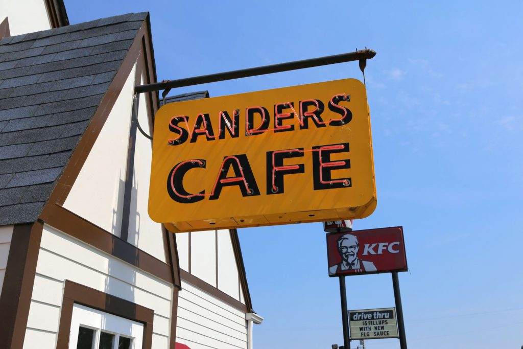 Comparing early signage from Sander's original fried chicken cafe and it's franchised spin-off: Kentucky Fried Chicken/