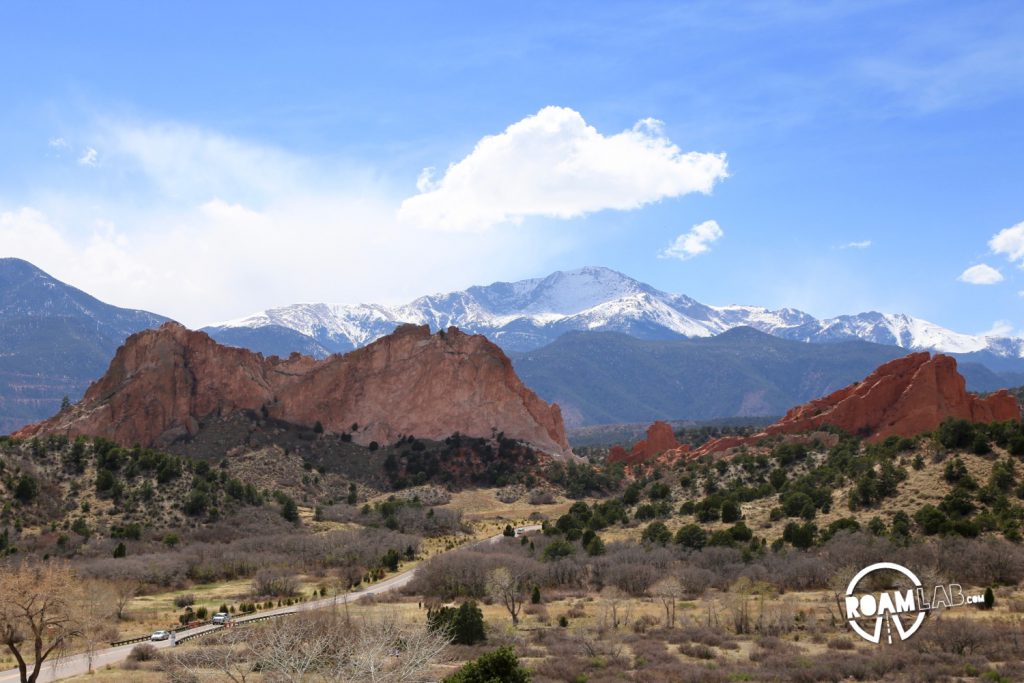 Pikes Peak towers over the Garden of the Gods. One awesome pile of rocks overlooking another.
