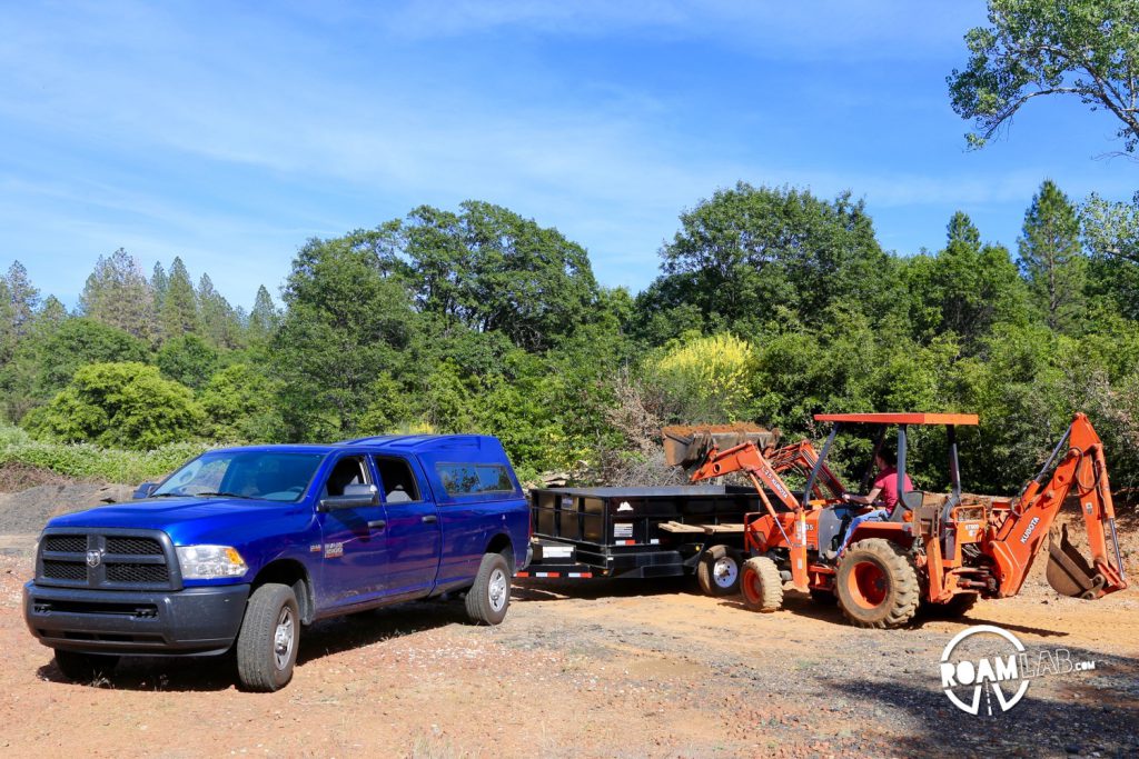 Filling the truck trailer with the bulldozer.