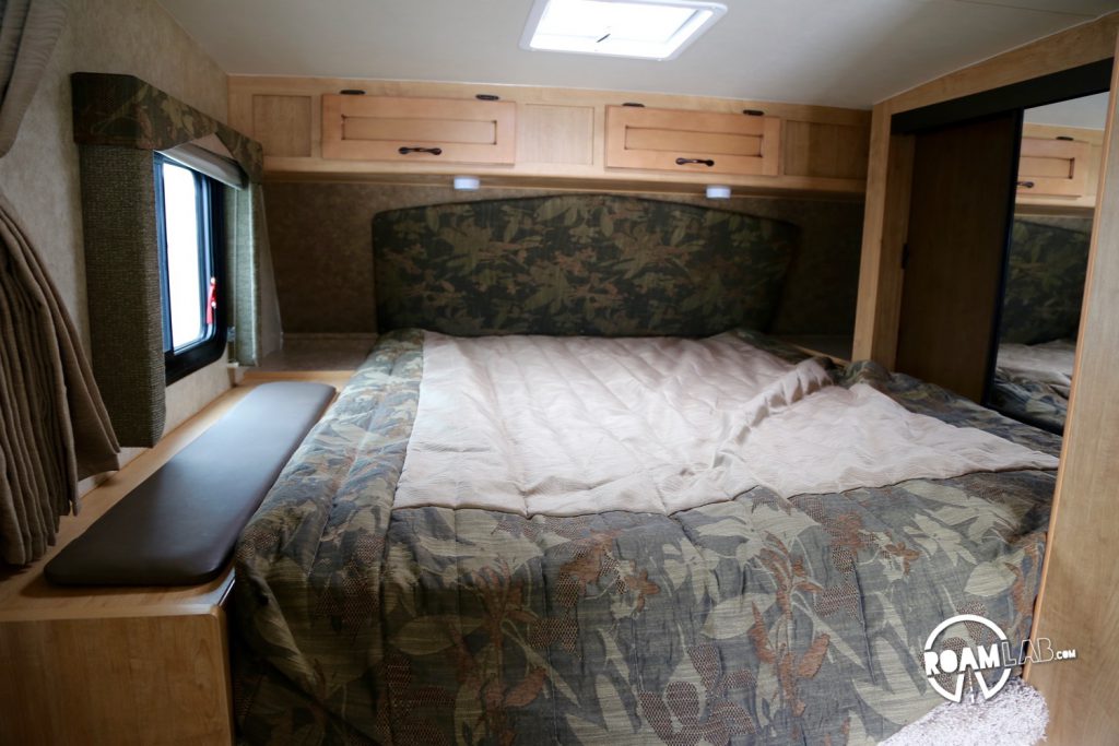 This sleeping area has a queen sized bed, which means that there is more storage space, such as the padded box to the left of the bed which flips up for storage or the mirrored closet on the right side where a few clothes can be hung.