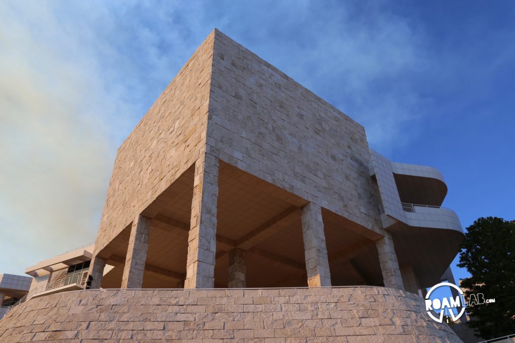 A side of the Getty illuminated by the rich light cast through clouds of rising smoke.