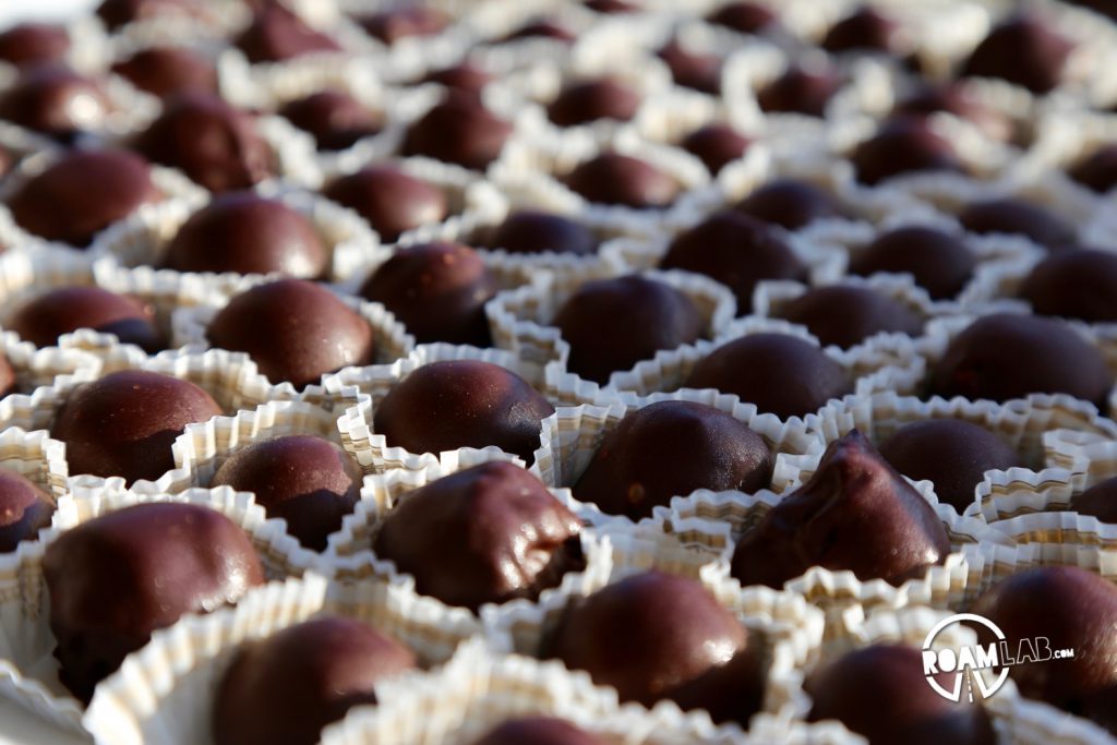 A spread of dark chocolate truffles, part of a lavish spread of crostini, duck egg rolls, Italian sliced meats,  and cheeses.