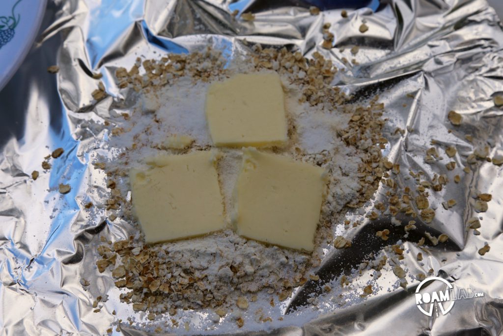 Oats, flour, butter, and sugar set on foil for the apple crisp.