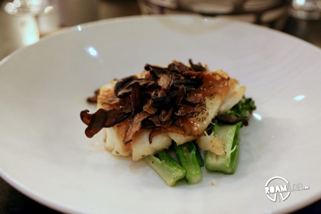 Chilean sea bass with a miso sauce, shiitake mushrooms, and broccolini.