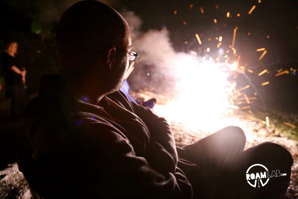 Revelers watch festive explosions on the beach.