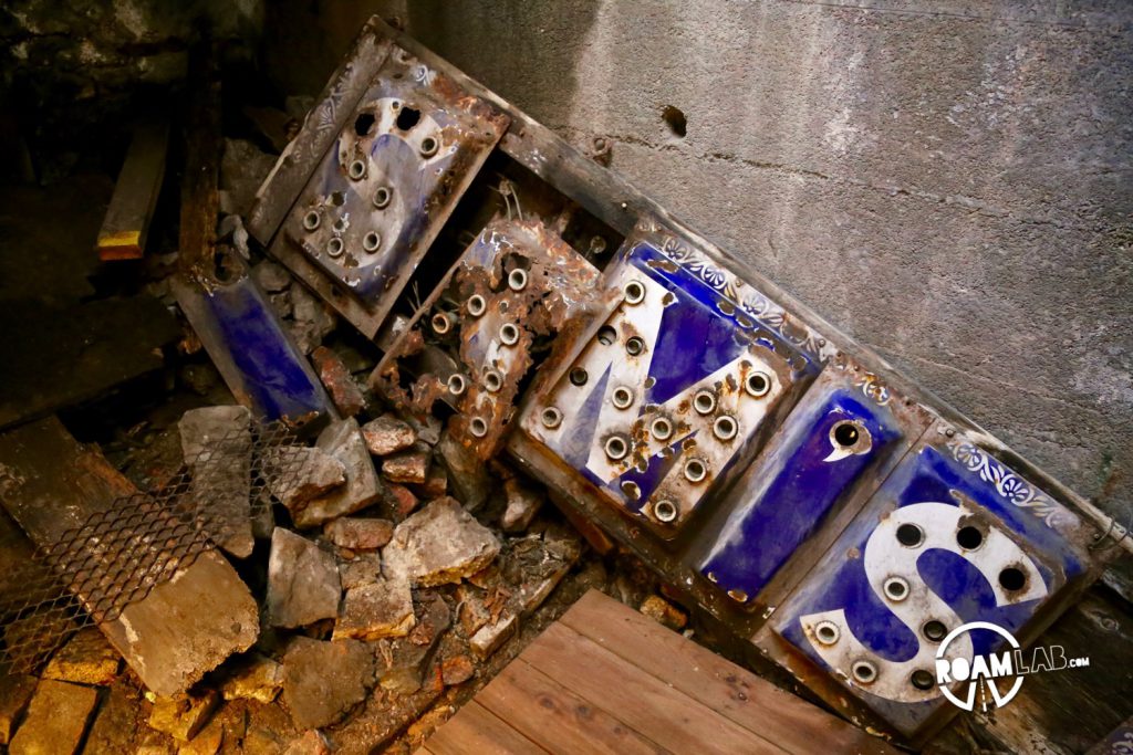 The Seattle Underground, once condemned, quickly became a cheap dumping place for the local businesses. Old beds, couches, and equipment such as this sign, were abandoned.