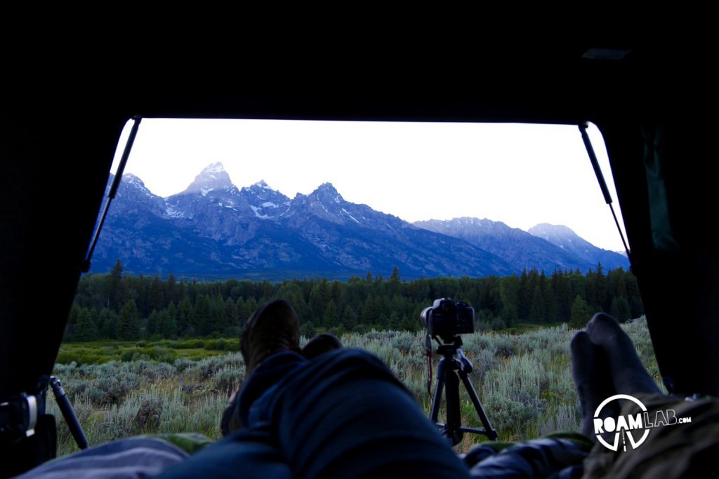 Camping out in the truck bed, as the sun sets over the Tetons. We had two tripods set up for quick shots in between sips of wine.