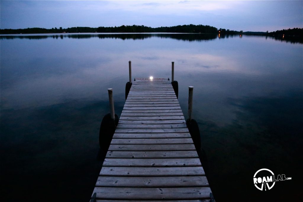 A dock, leading out into the dusky waters.