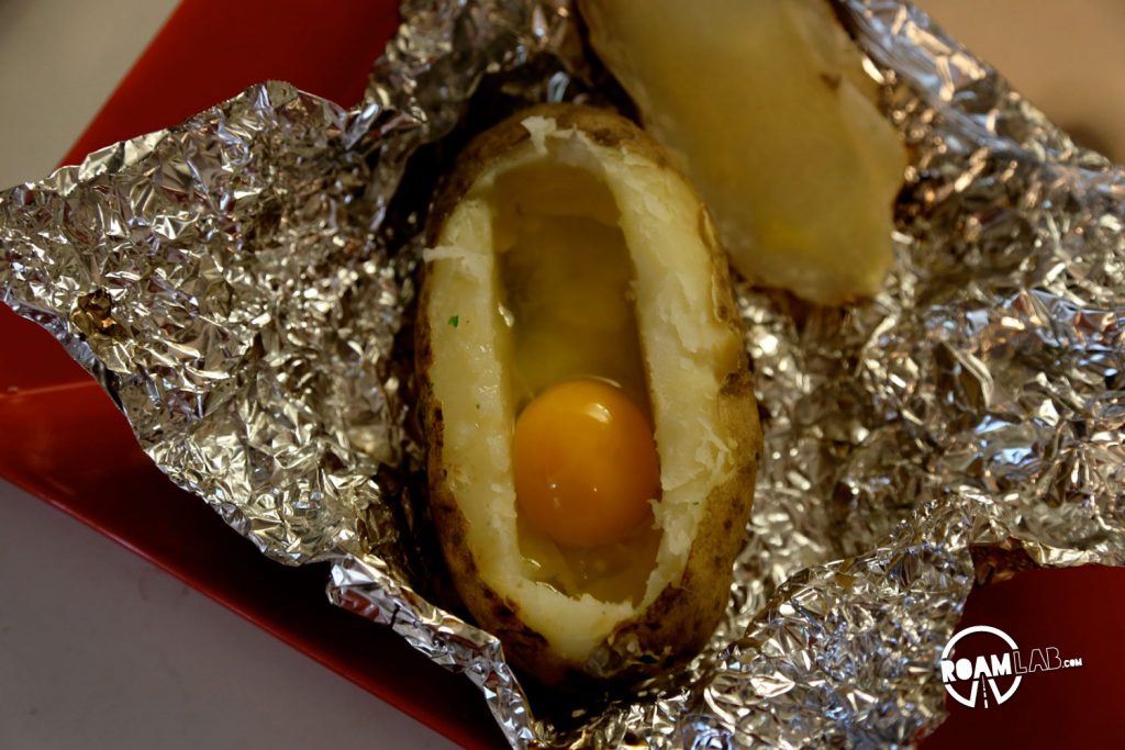 Stoke up that fire for an amazingly delicious Hiker's Bacon And Egg Potato Boat Breakfast