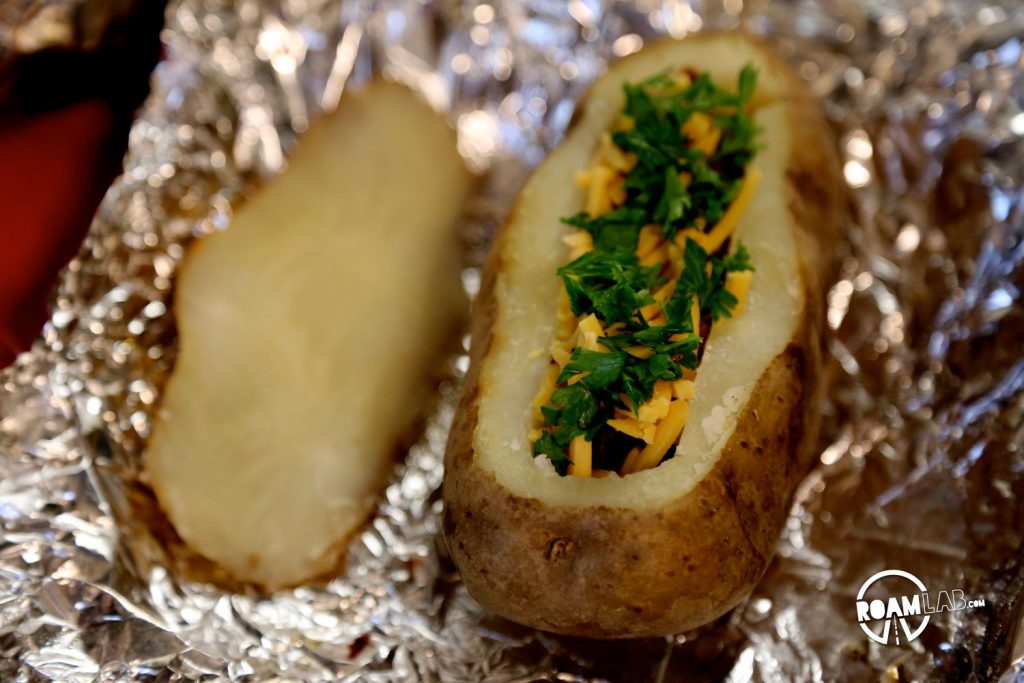 Stoke up that fire for an amazingly delicious Hiker's Bacon And Egg Potato Boat Breakfast