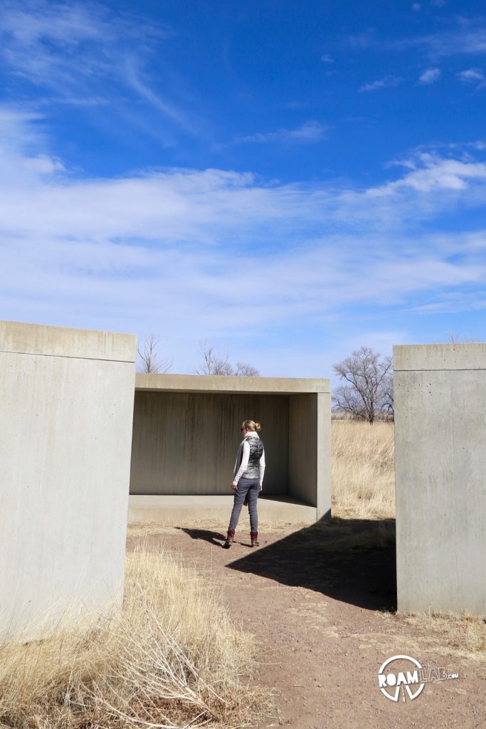 Exploring a collection of concrete sculptures by Donald Judd outside the Chinati Foundation.