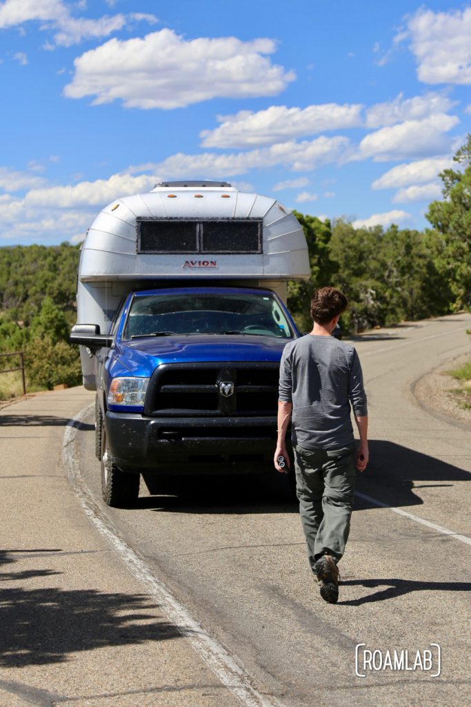 Man walking up to a vintage Avion C11 truck camper