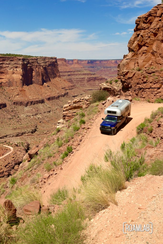 Aluminum Avion C11 truck camper driving down Shafer Road through Canyonlands National Park.