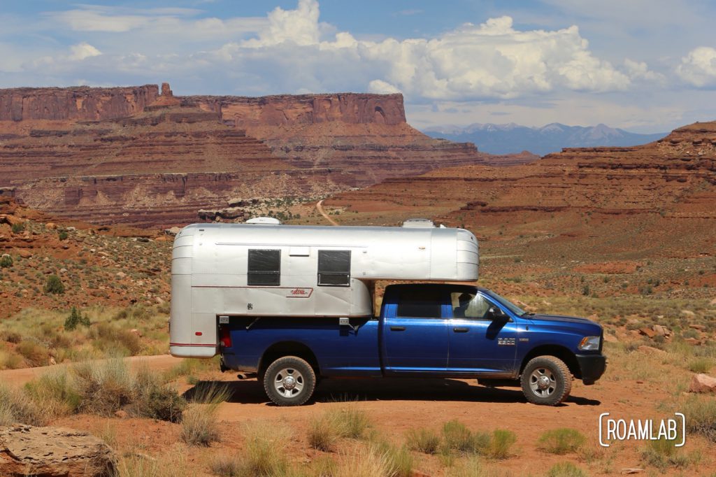 Aluminum Avion C11 truck camper driving down Shafer Road through Canyonlands National Park.