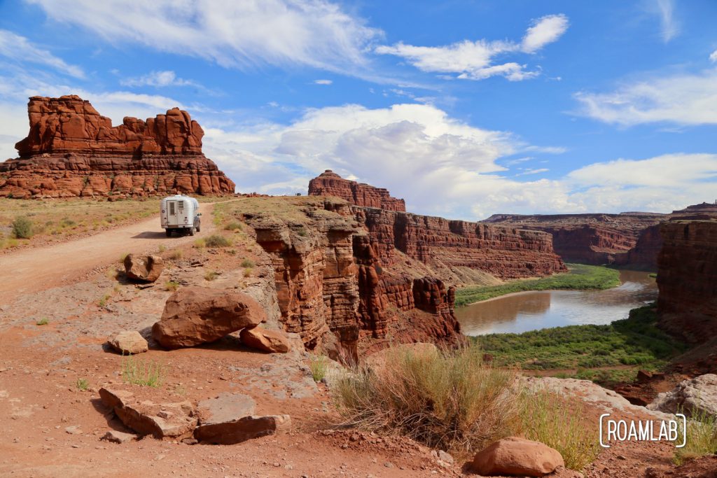 Aluminum Avion C11 truck camper driving down Shafer Road through Canyonlands National Park.