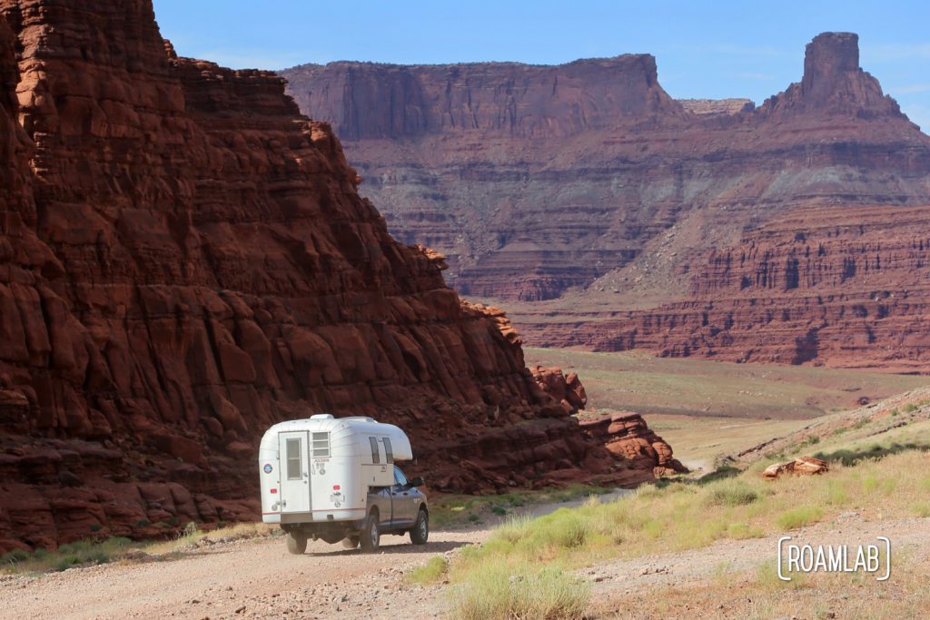 Aluminum Avion C11 truck camper driving down Shafer Road through Canyonlands National Park.