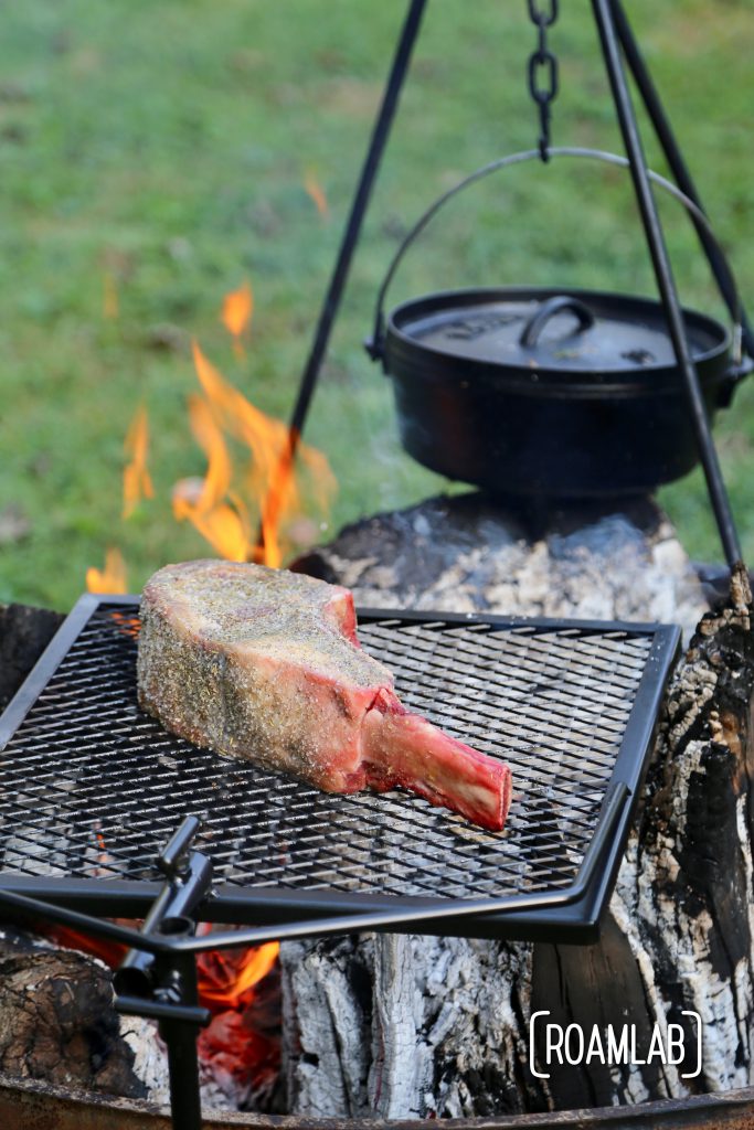 Grilling tomahawk steak over and open campfire is a challenging and delicious undertaking.