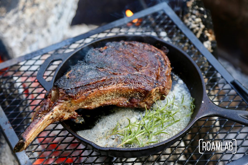 Grilling tomahawk steak over and open campfire is a challenging and delicious undertaking.