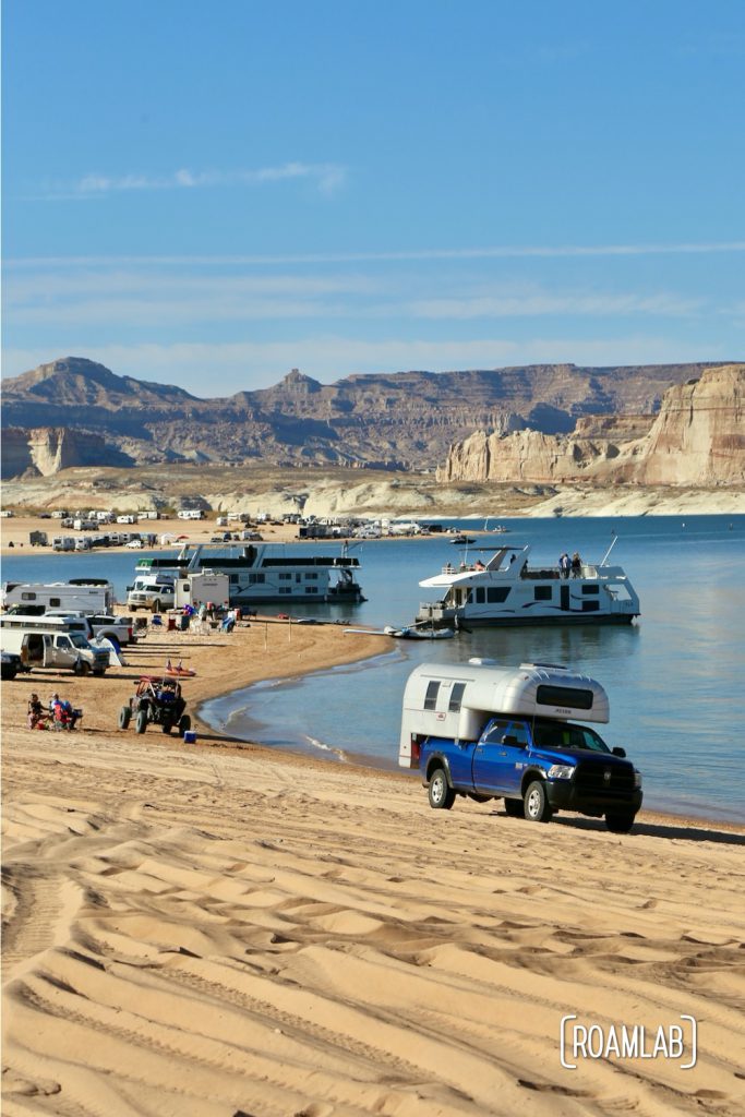 Beach camping along Lake Powel for off-road vehicles at Lone Rock Campground in Glen Canyon National Recreation Area just north of Page, Arizona.