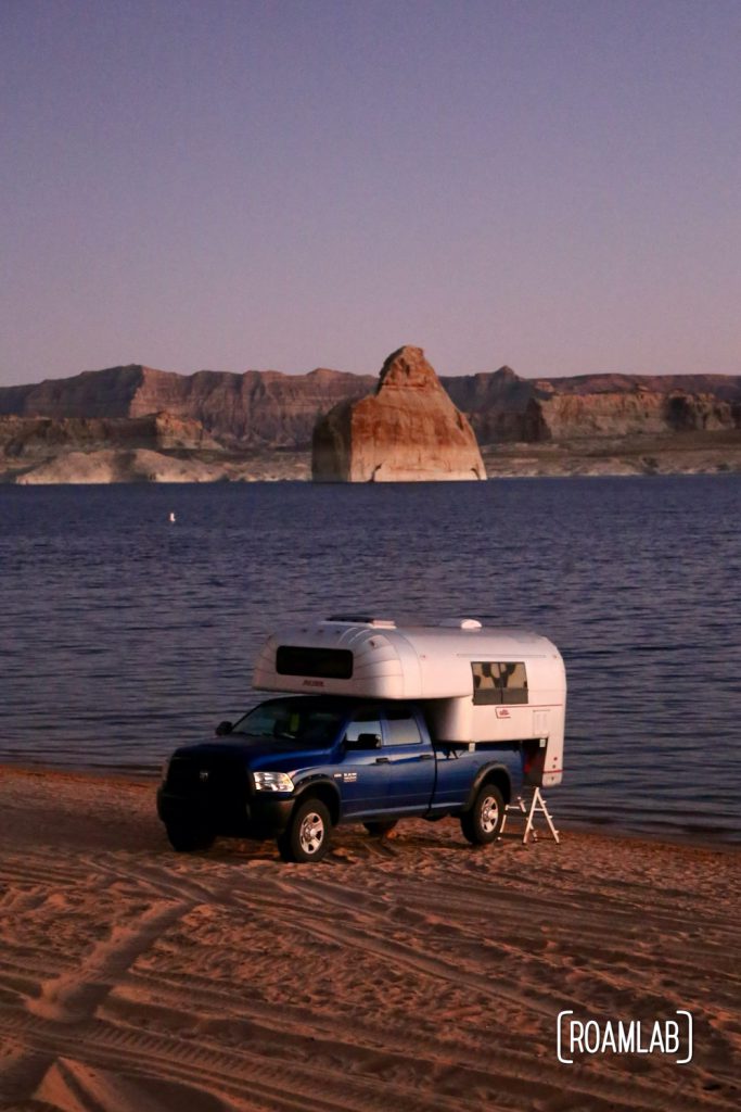 Beach camping along Lake Powel for off-road vehicles at Lone Rock Campground in Glen Canyon National Recreation Area just north of Page, Arizona.