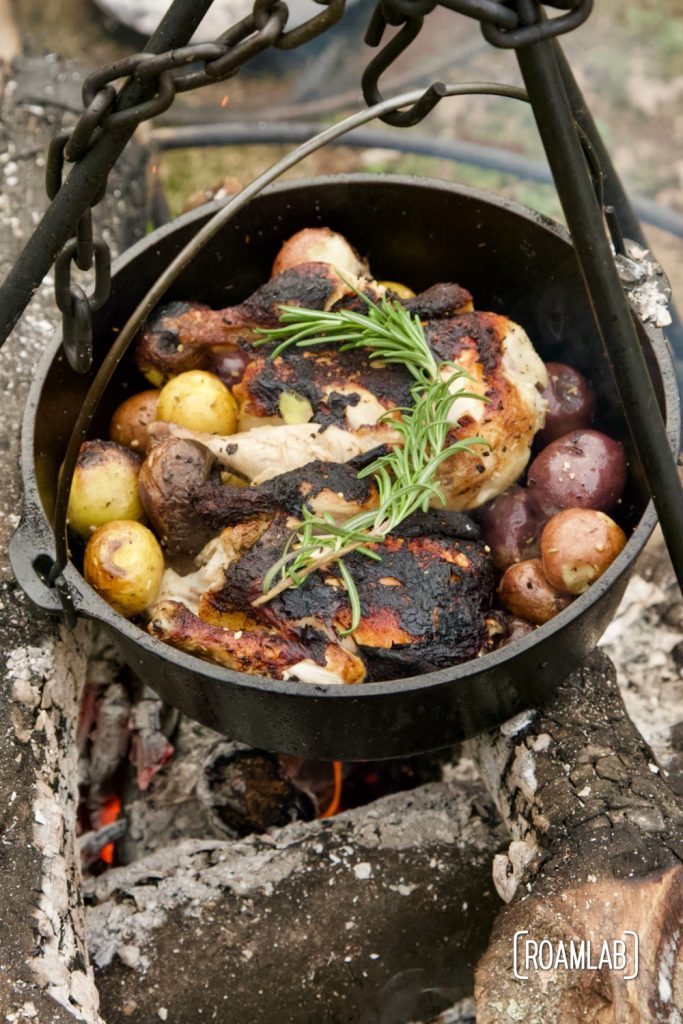 Roast this rosemary cornish game hen and potatoes recipe in a dutch oven over an open camp fire for a classy campground dinner or in your oven at home.