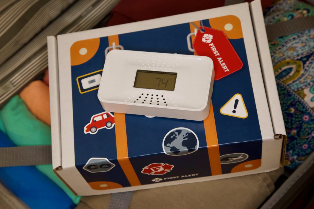 First Alert's portable tabletop CO alarm ready to be packed into a suitcase.