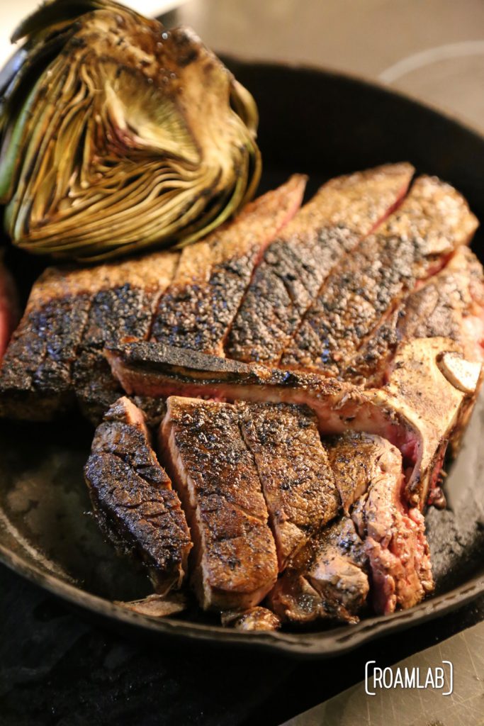 Cast iron skillet seared porterhouse steak and artichoke.