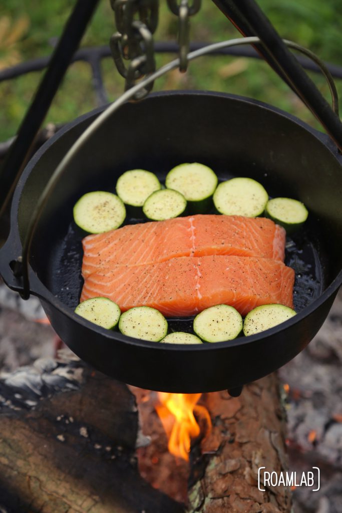 Frying cast iron skillet fried salmon with mango salsa and mozzarella zucchini.