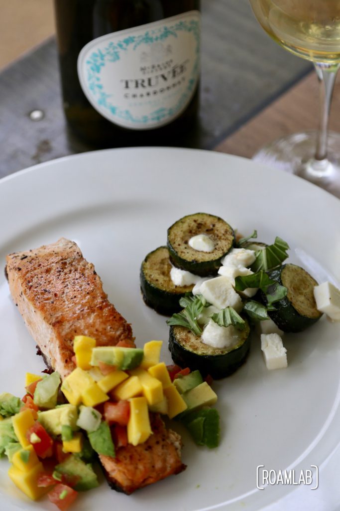 Cast iron skillet fried salmon with mango salsa and mozzarella zucchini.