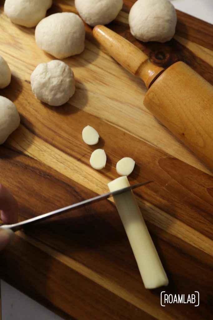 Preparing cast iron skillet cheesy buns.