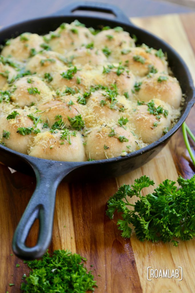 Cast iron skillet cheesy buns and parsley.