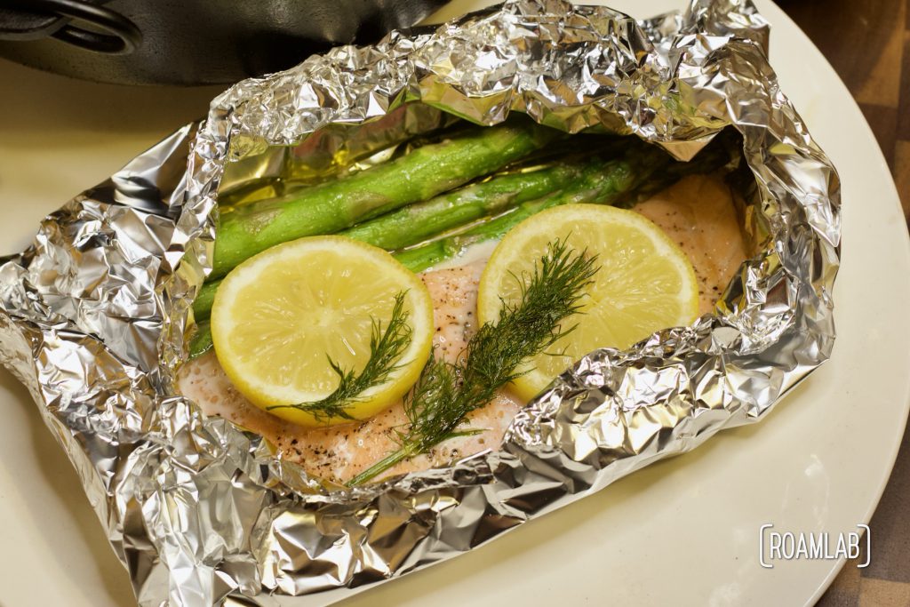 Enjoy this simple seafood course with our tin foil salmon campfire cooking dinner recipe. Add veggies with the fillet to make a full meal in one packet.