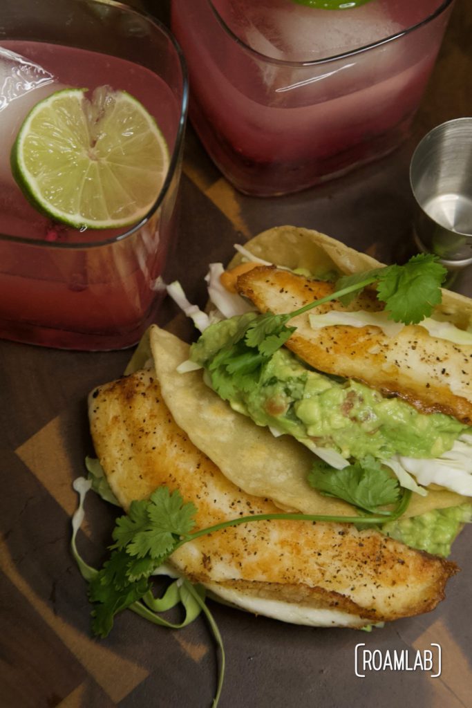 Tilapia fish tacos with guacamole and pomegranate margaritas.