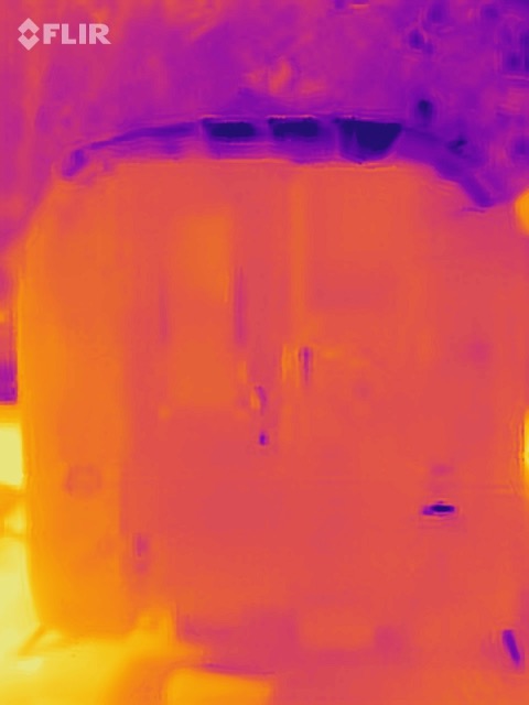 Thermal image of truck camper rear exterior with FLIR watermark in upper left-hand  corner