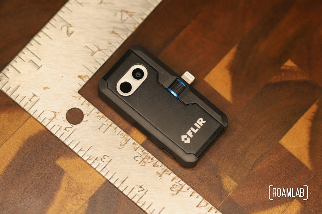 FLIR One Pro thermal camera case next to a ruler.