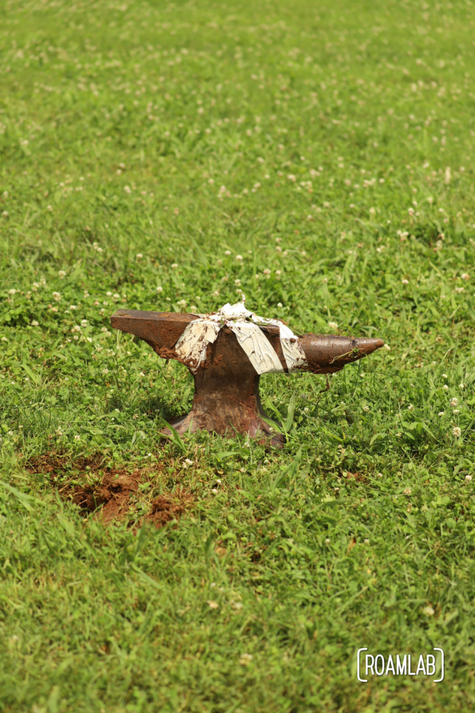 Anvil sitting on the grass after being pulled out of the ground at the end of an anvil shoot.