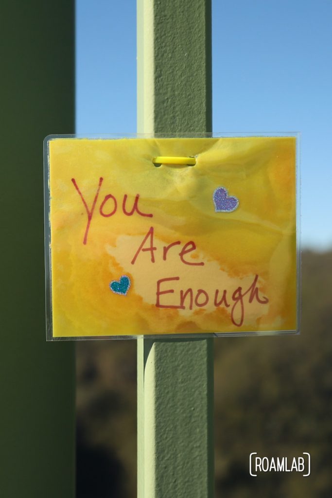 Laminated message tied to Foresthill Bridge: "You Are Enough"