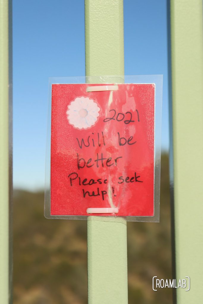 Laminated message tied to Foresthill Bridge: "2021 will be better. Please seek help!"