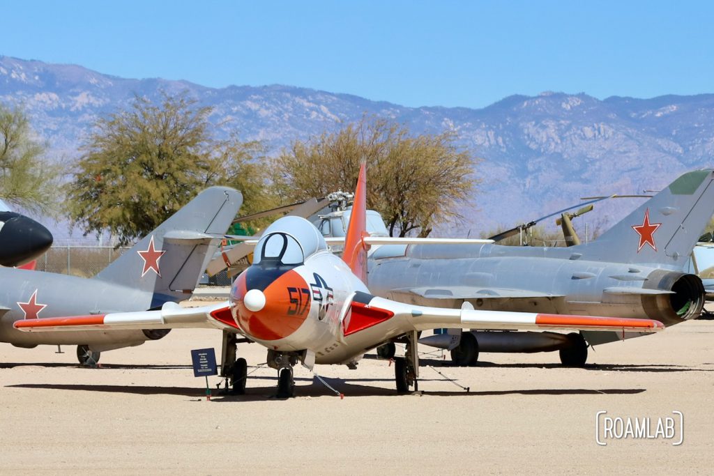 Colorful fighter planes scattered across the outdoor exhibits of the Pima Air & Space Museum.