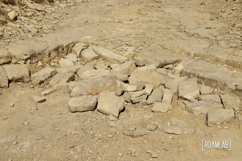 Large broken pieces of rock piled against a rock ledge on Old Ore Road in Big Bend National Park, Texas.