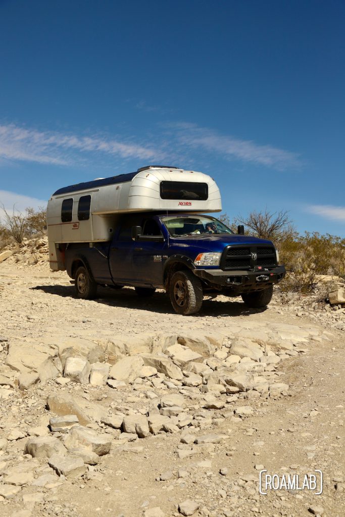 1970 Avion C11 truck camper on a large rock ledge along Old Ore Road in Big Bend National Park, Texas