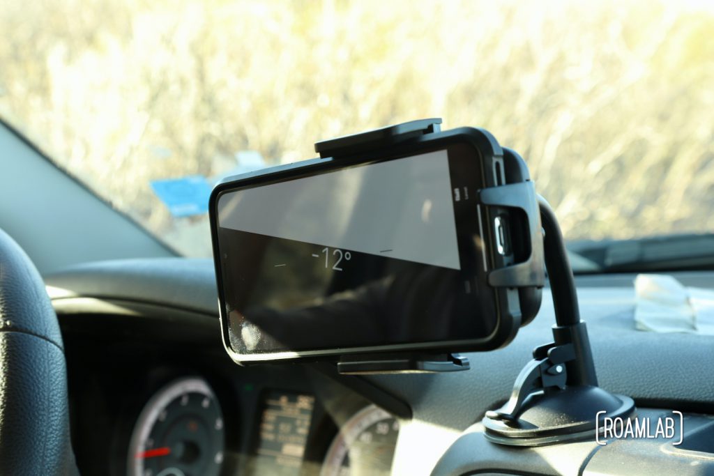 Cell phone mounted on a truck dashboard with a level app marking a -12% angle.