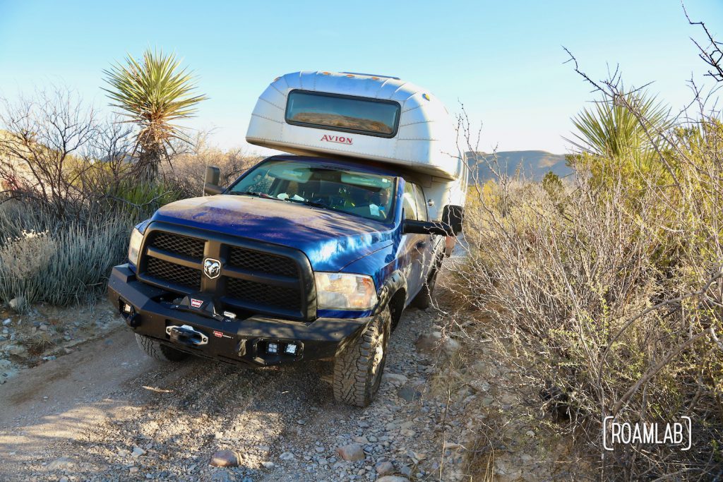 Shaded 1970 Avion C11 truck camper at an angle while driving along the Old Ore Road in Big Bend National Park, Texas.