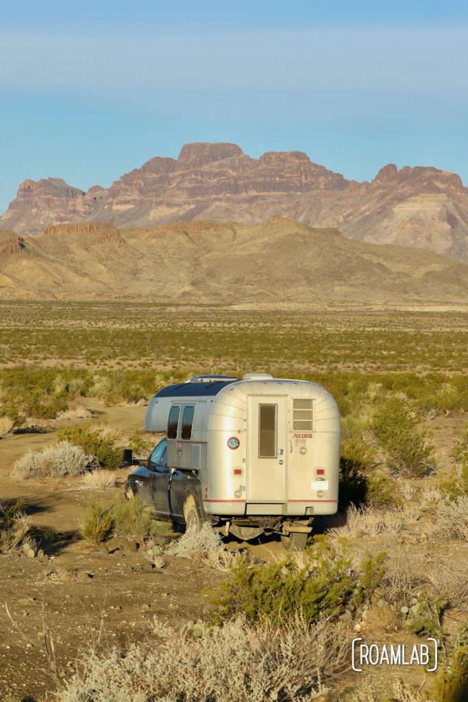 Golden 1970 Avion C11 trruck camper driving towards the Chisos Mountains in the Big Bend National Park in south west Texas.