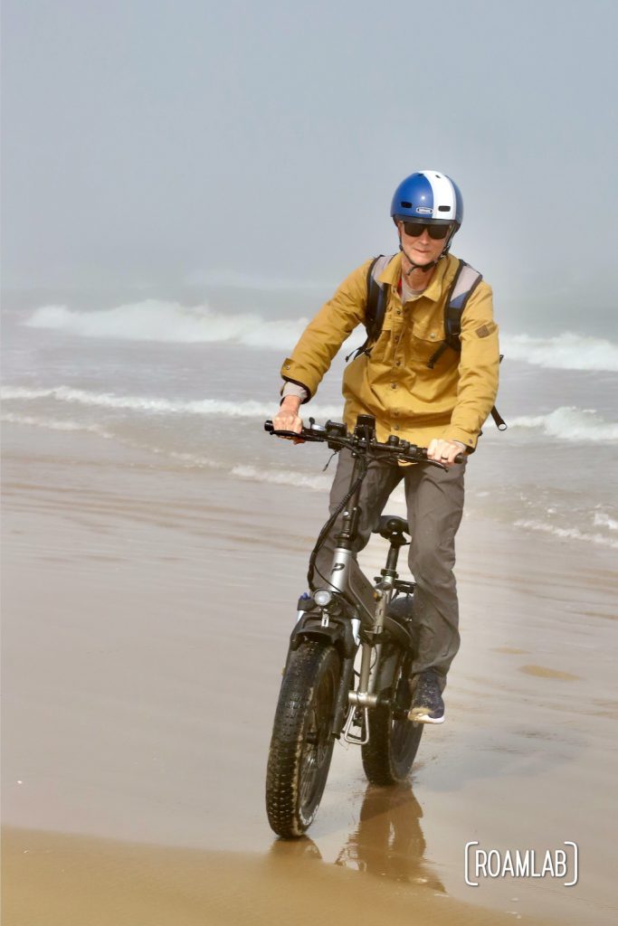 Man biking along the beach in South Padre Island, Texas
