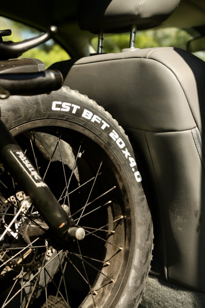 Bike tire pushed against the back of a car seat.