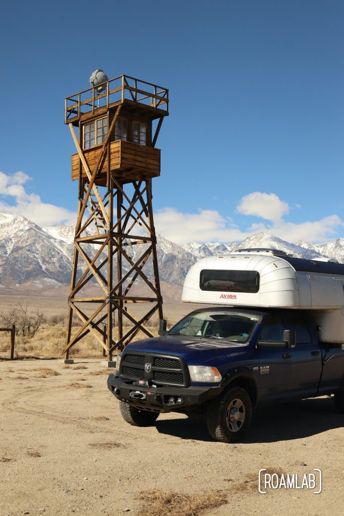 Manzanar watch tower reconstruction with a 1970 Avion C11 truck camper with the Sierra Nevada in the background.