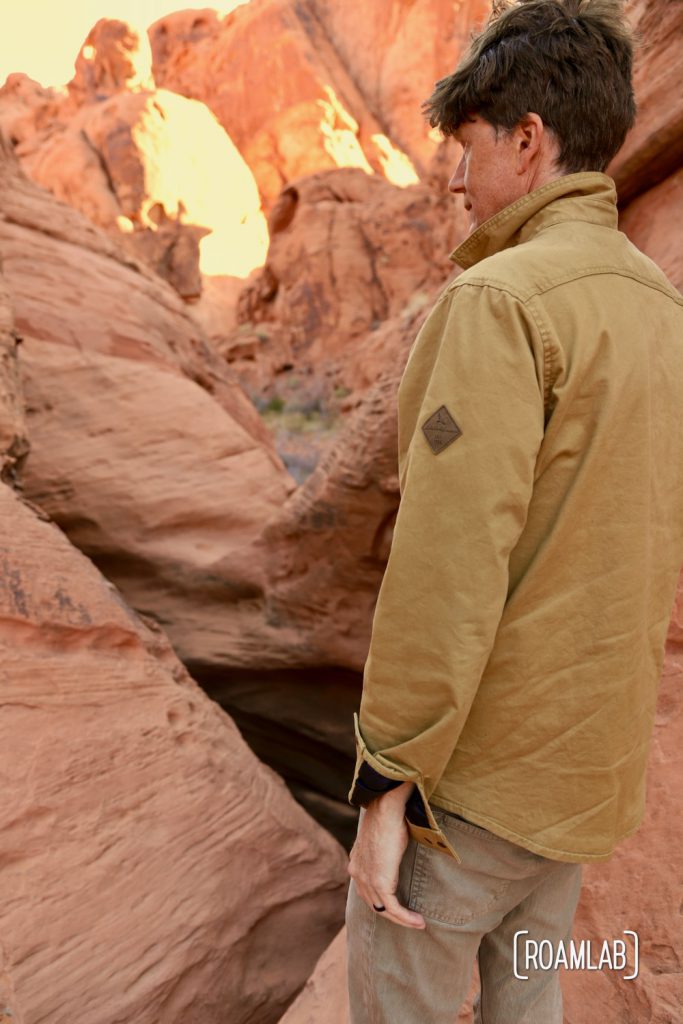Man looking into the natural reservoir of Mouse Tank, Valley of Fire State Park.