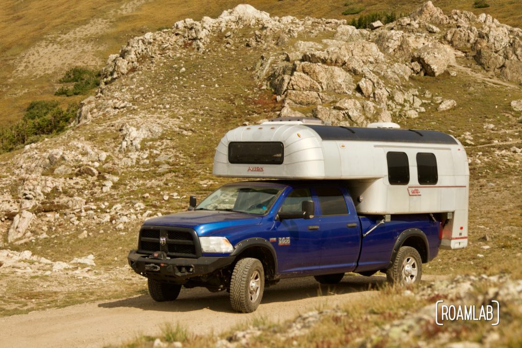 1970 Avion C11 truck camper on a 2015 Ram 2500 tradesman truck camper driving through the alpine tundra on Old River Road in Rocky Mountain National Park.